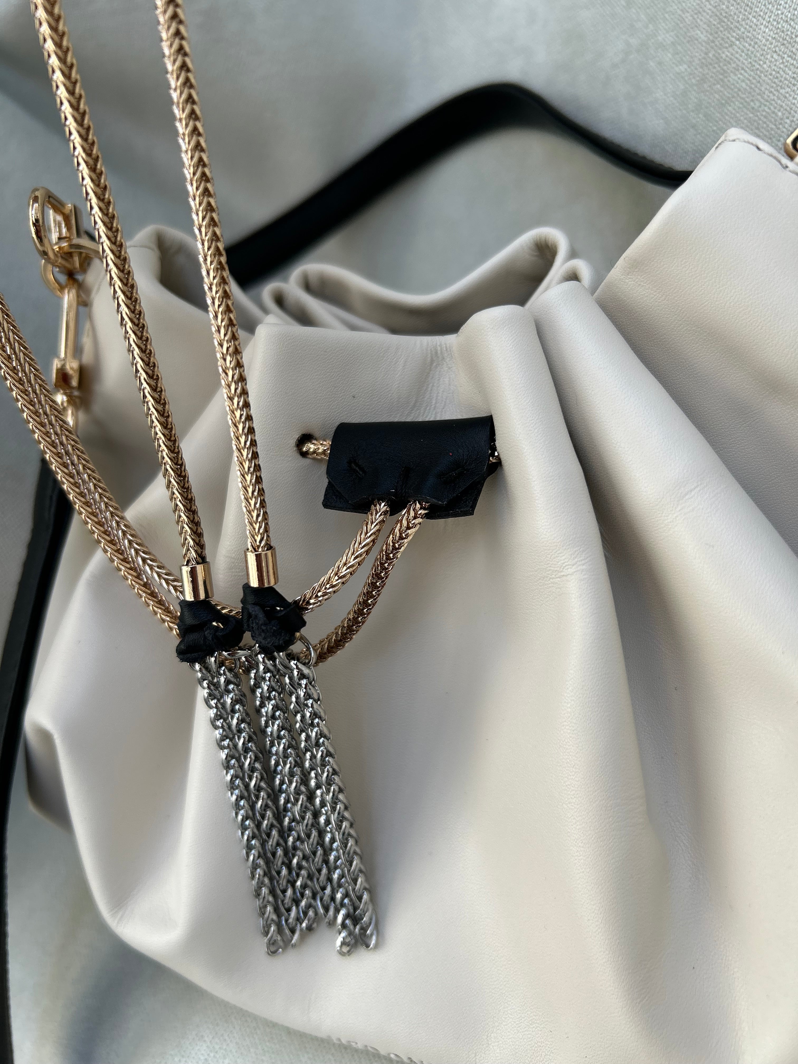 Mini "Retro" bag with a handle and a shoulder strap. Black and white leather.