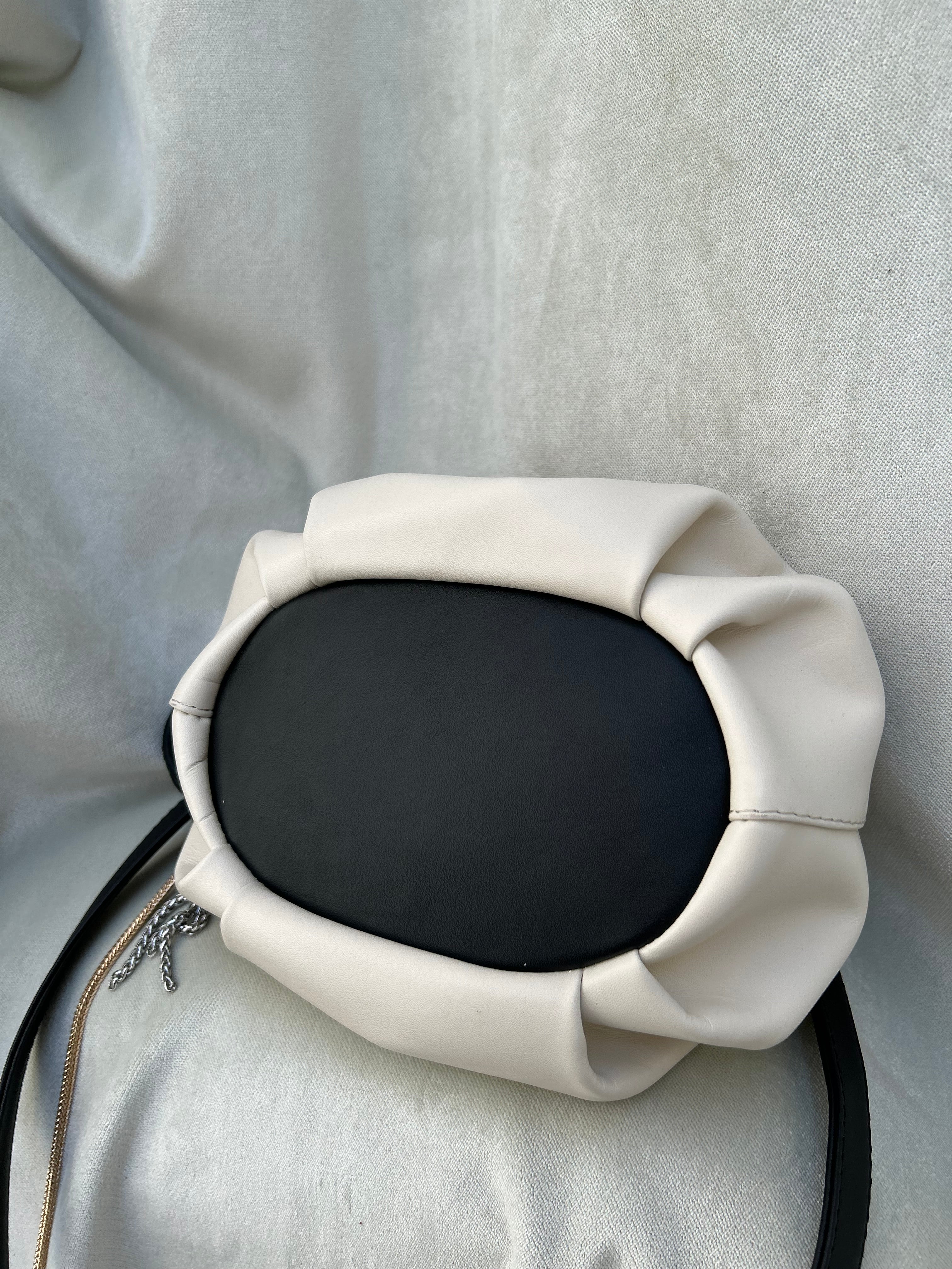 Mini "Retro" bag with a handle and a shoulder strap. Black and white leather.