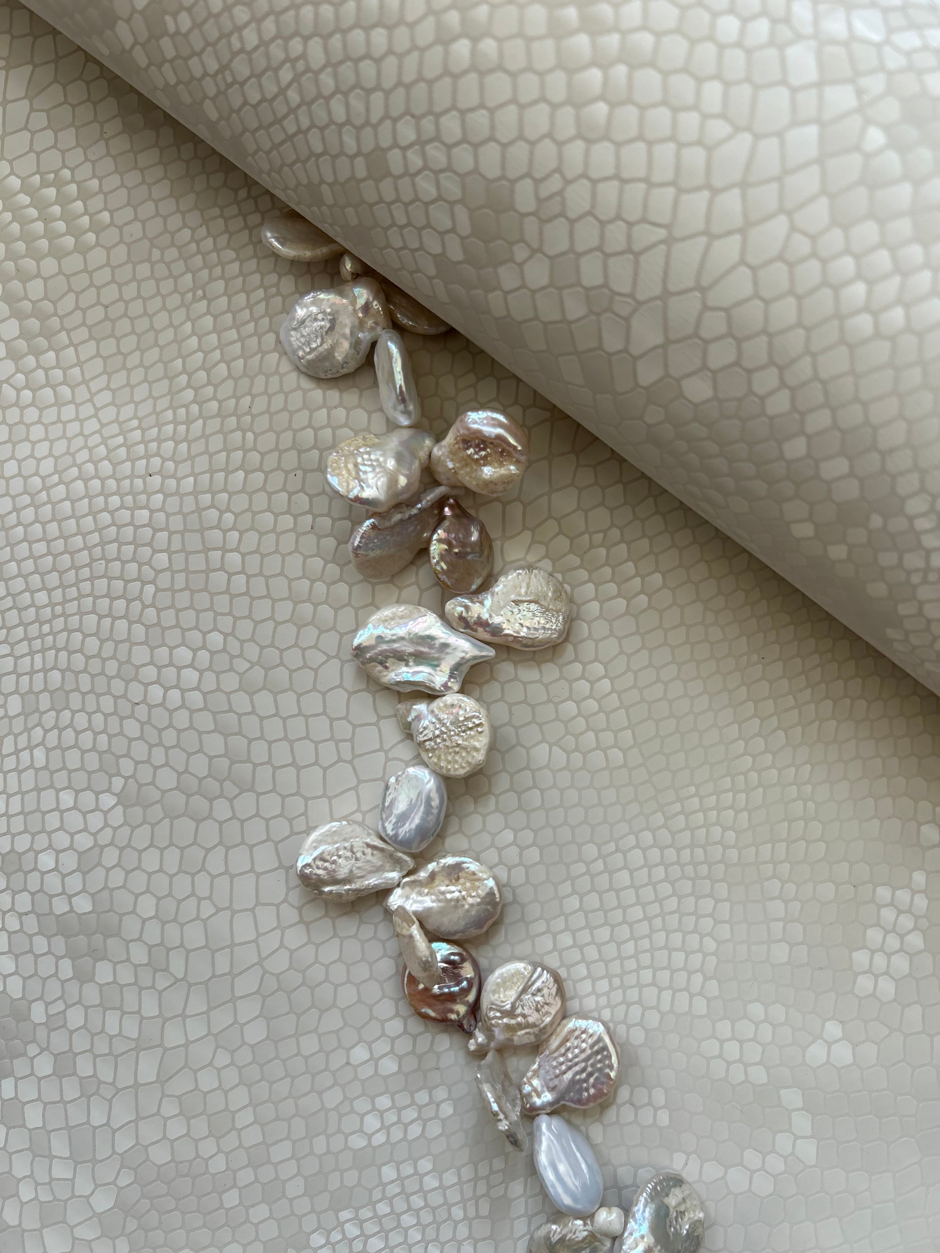 "Audrey M+" snake-embossed leather with freshwater pearls. Available in two colors.