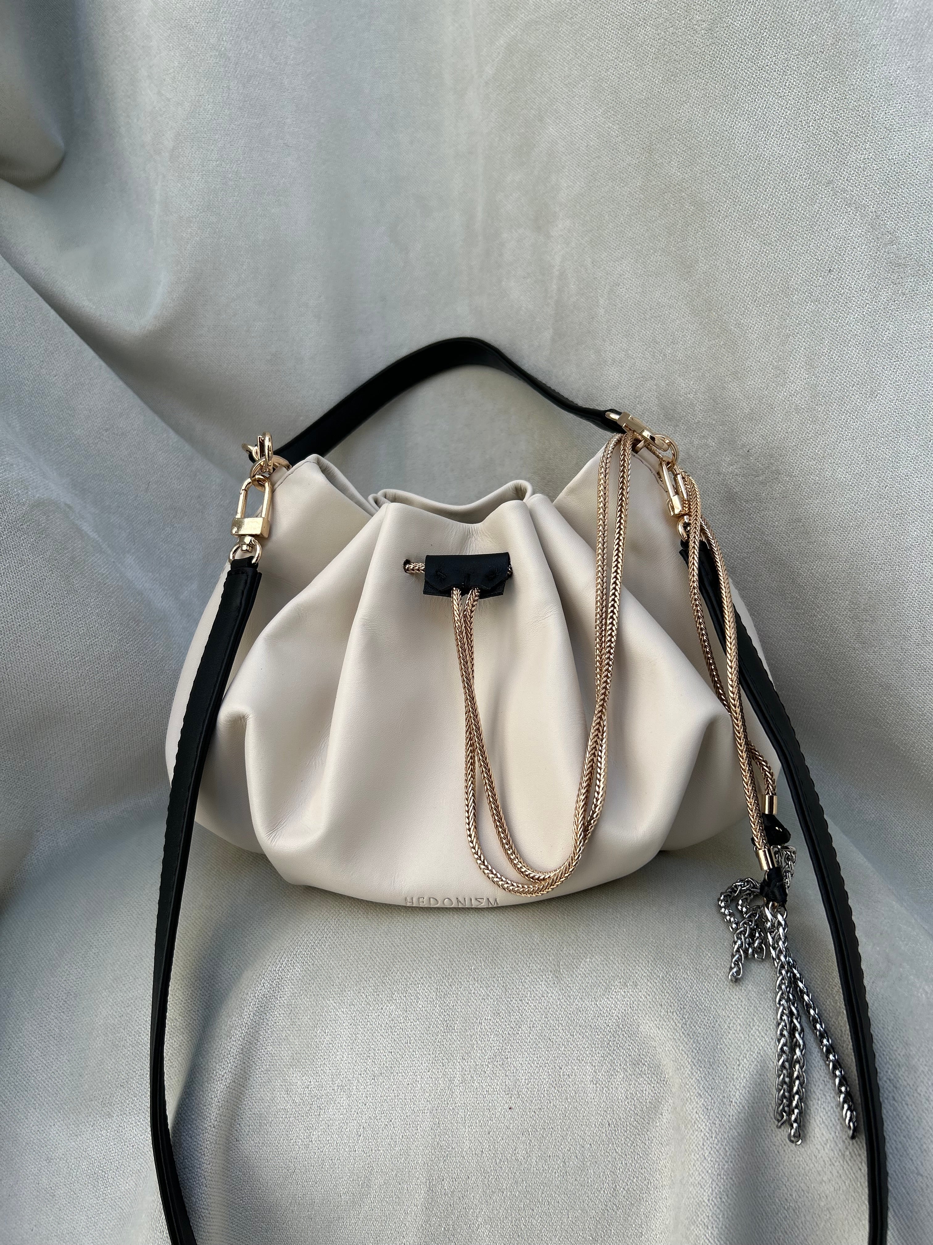 Mini "Retro" bag with a handle and a shoulder strap. Black and white leather.