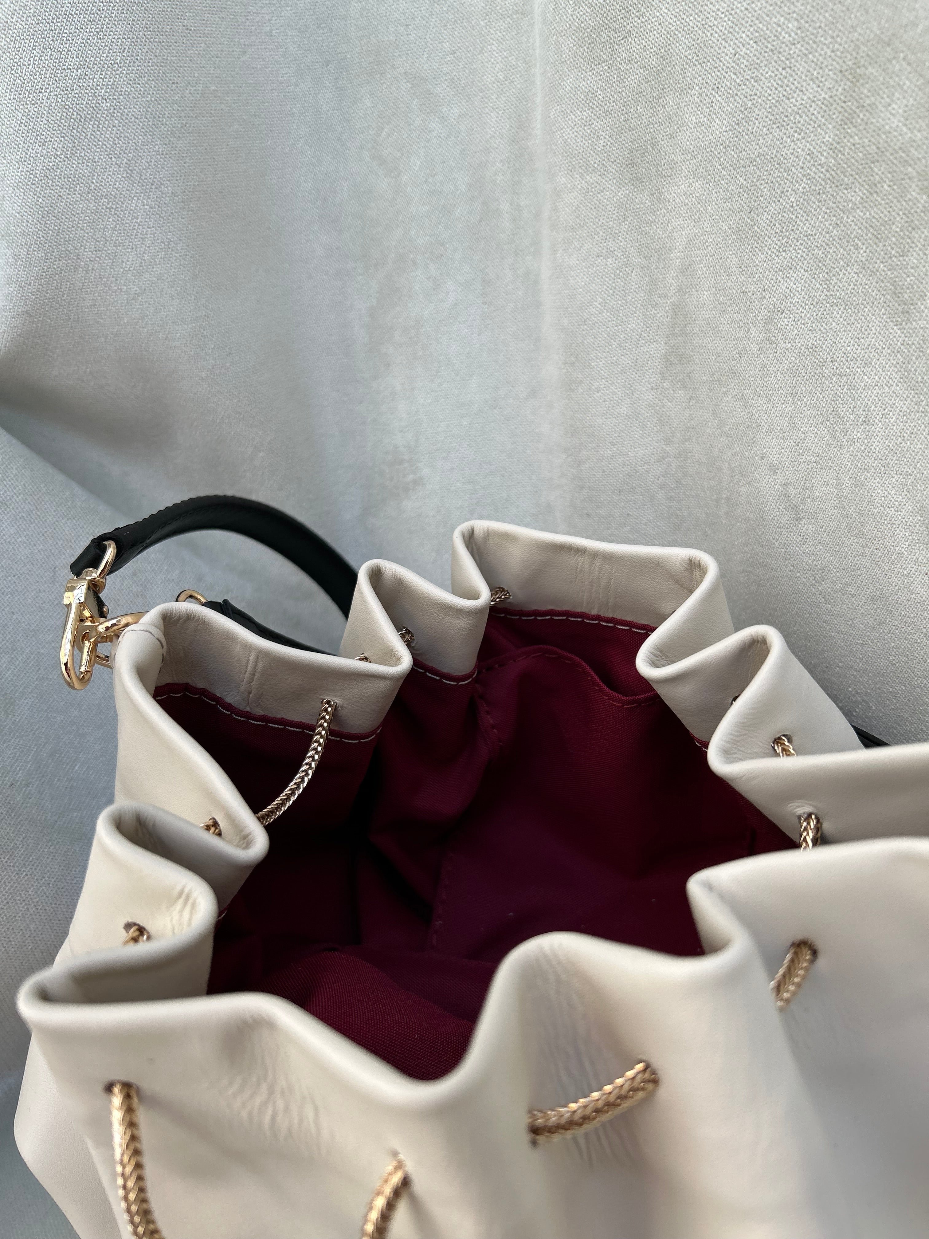 Mini "Retro" bag with a handle and a shoulder strap. Black and white leather.