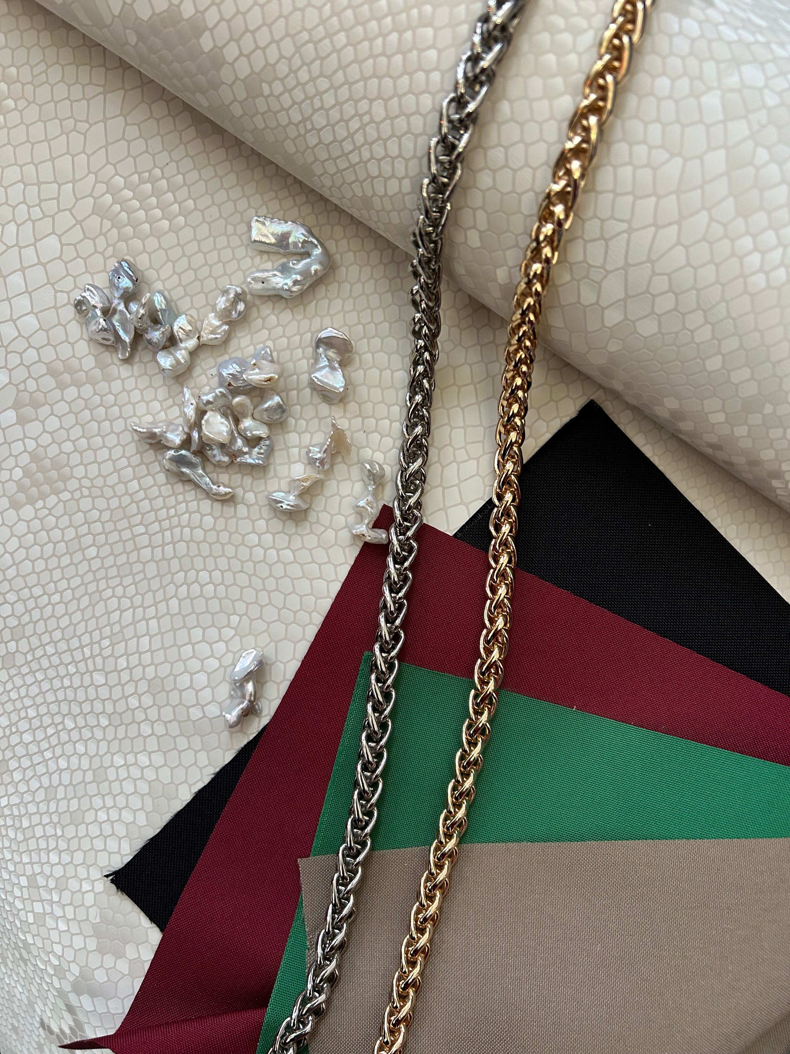 "Audrey M+" snake-embossed leather with freshwater pearls. Available in two colors.