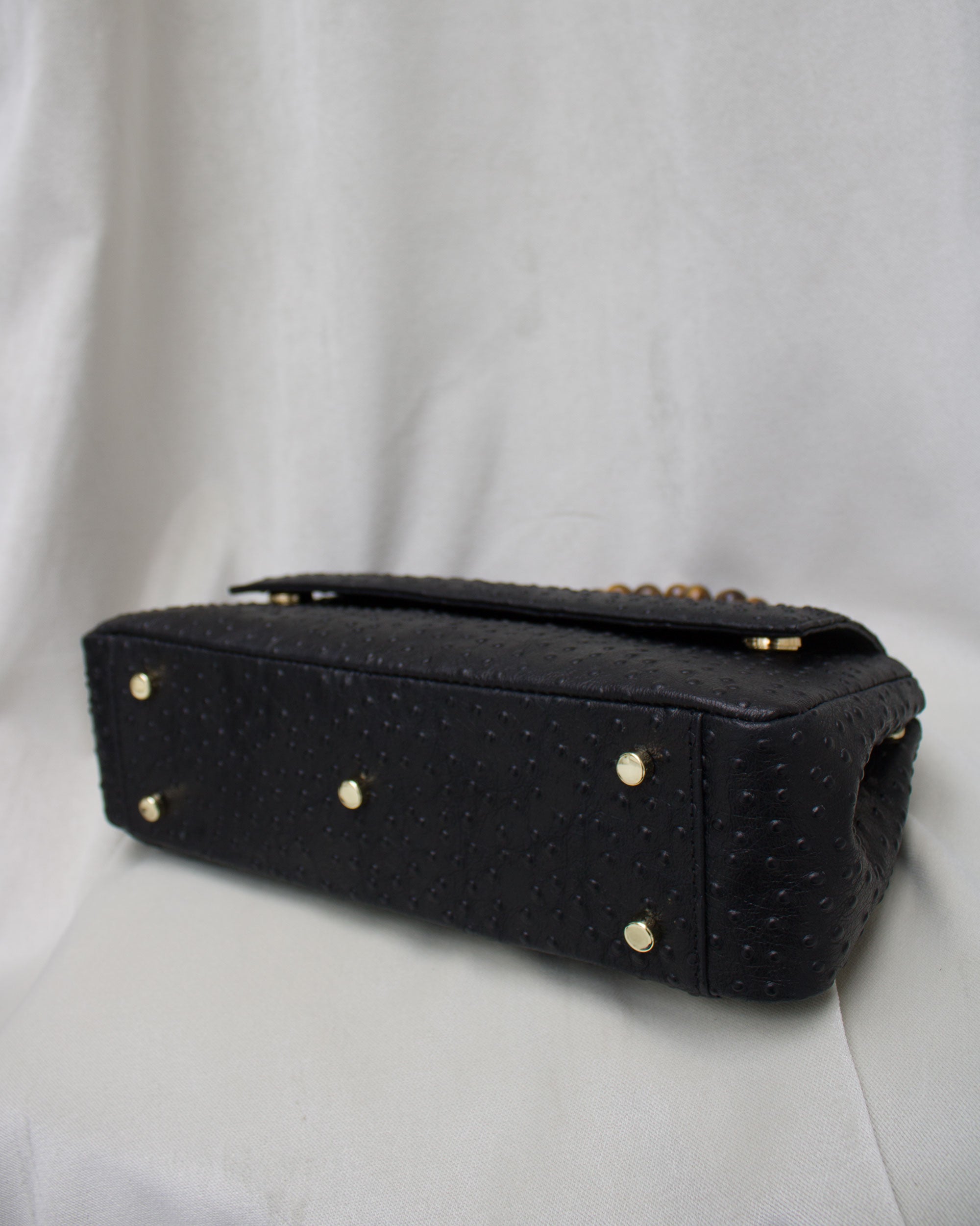 "Audrey Baguette" with tiger's eye, ostrich-embossed leather. Available in two colors