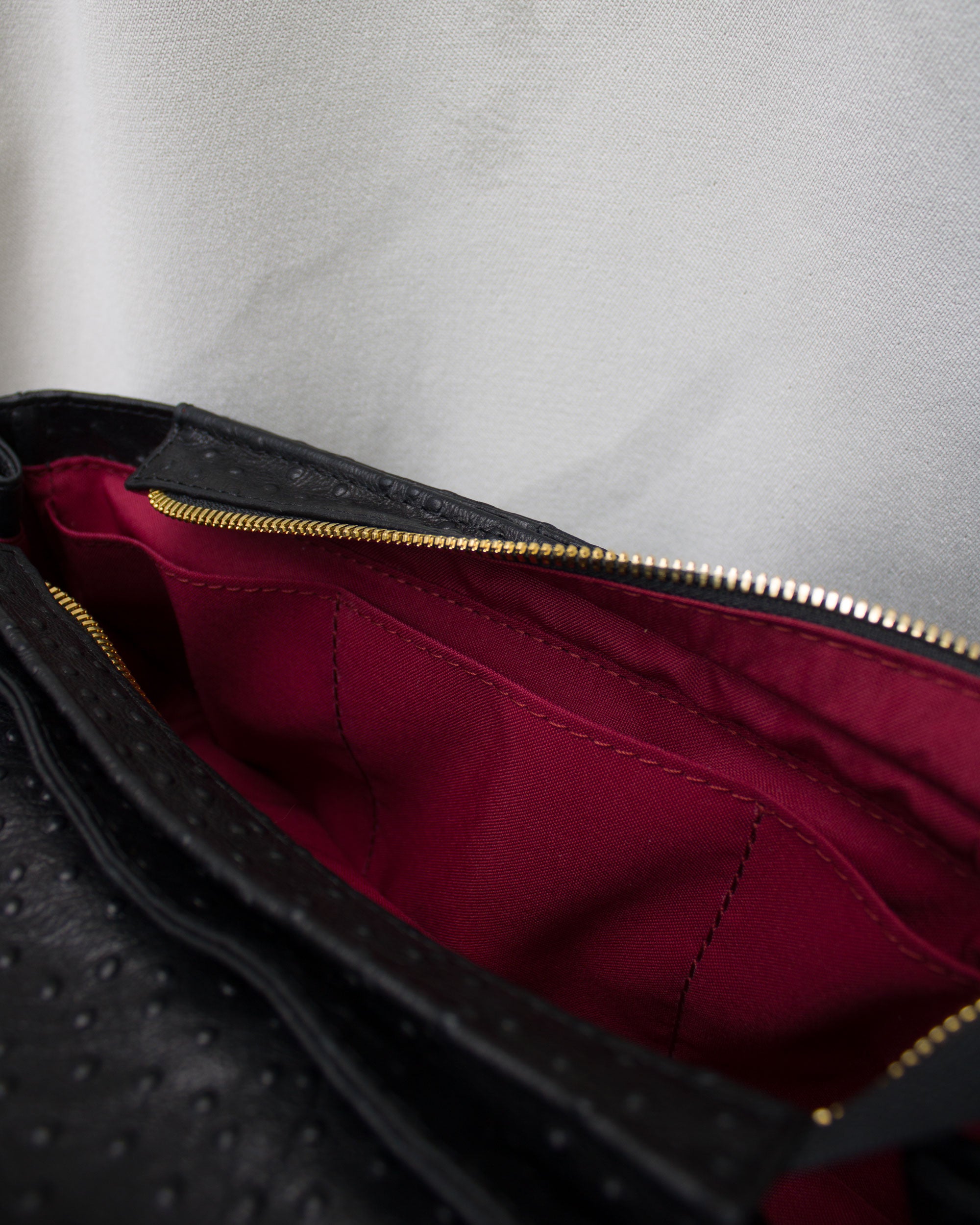 "Audrey Baguette" with tiger's eye, ostrich-embossed leather. Available in two colors