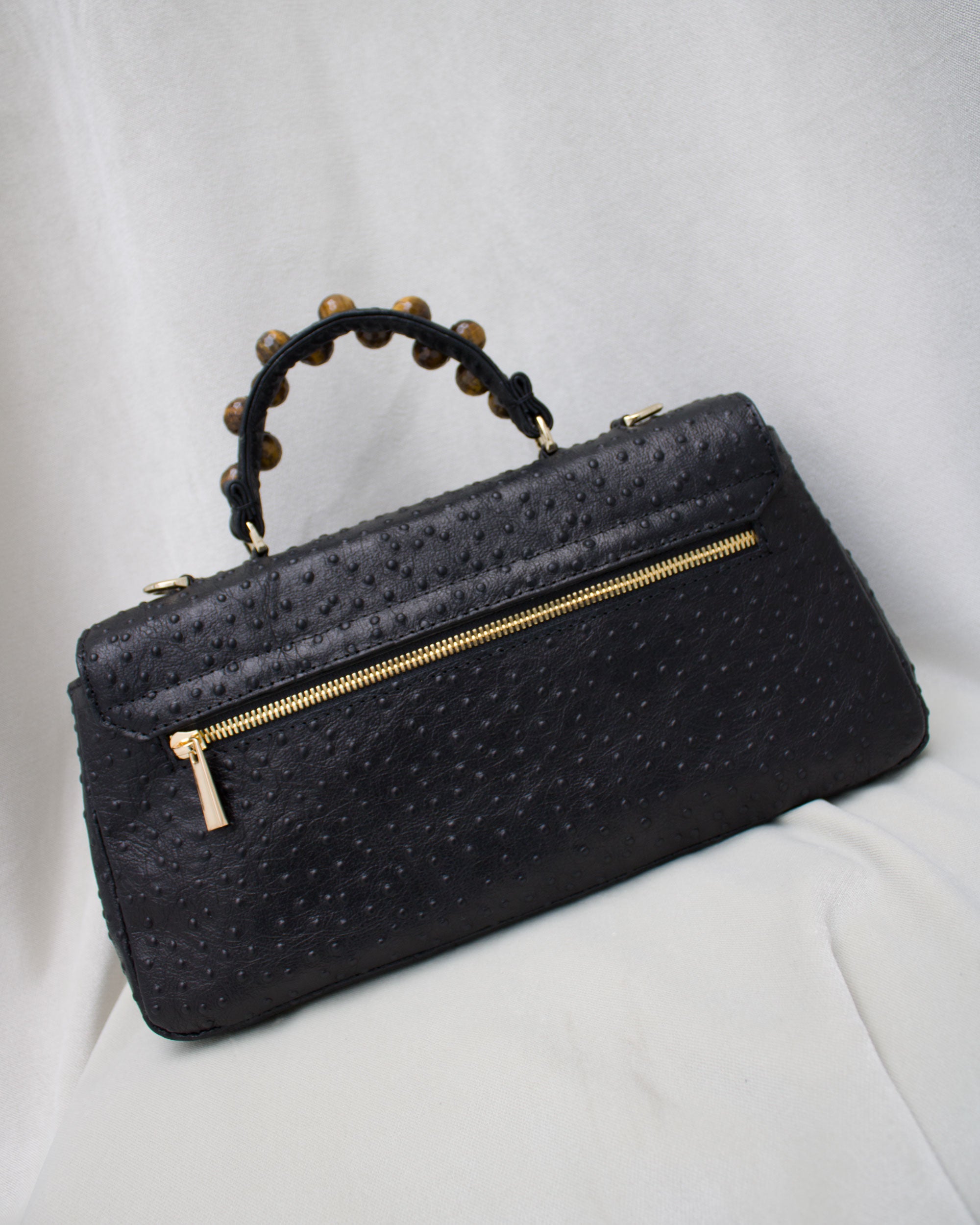 "Audrey Baguette" with tiger's eye, ostrich-embossed leather. Available in two colors