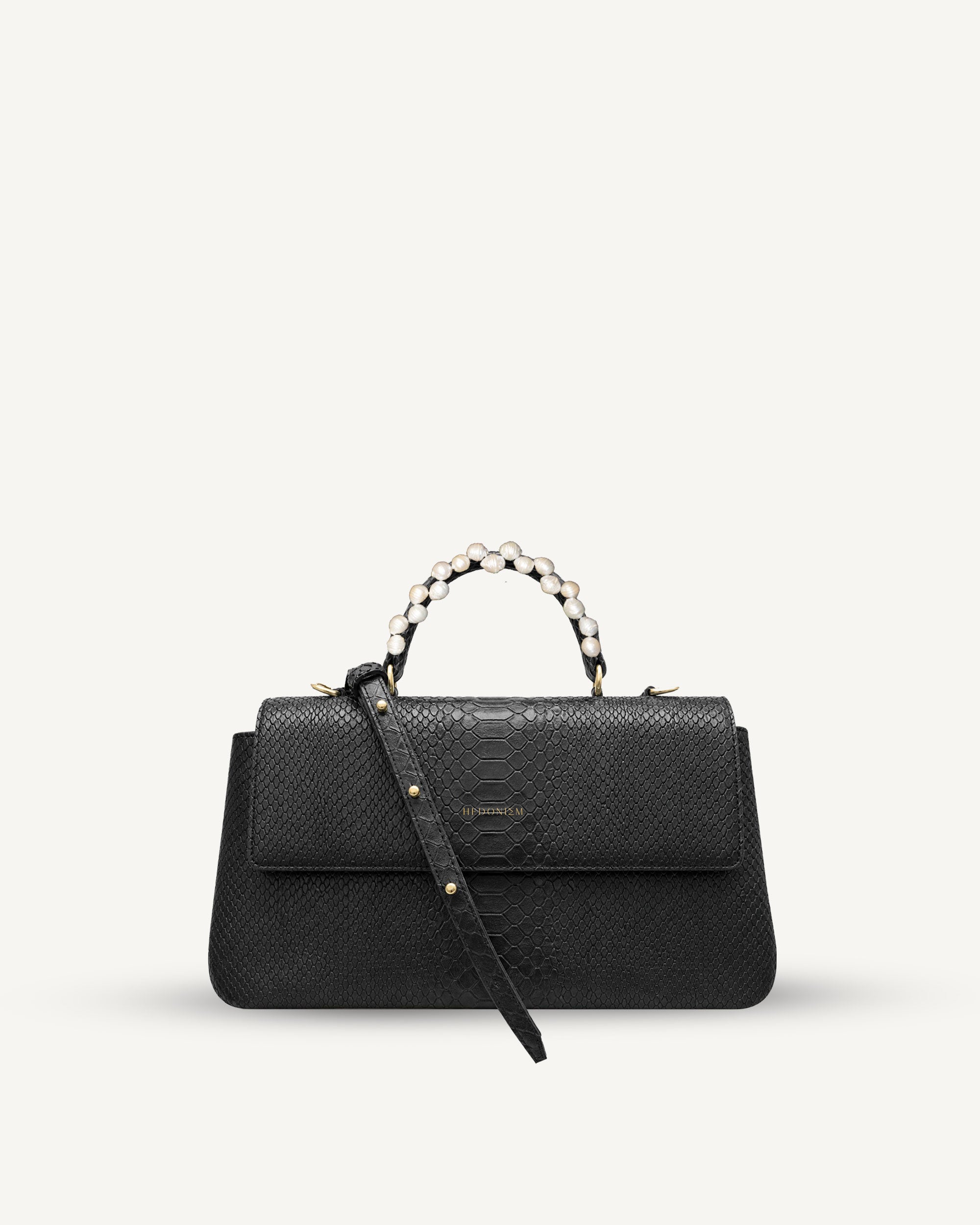"Audrey" snake-embossed leather with freshwater pearls. Available in two colors.