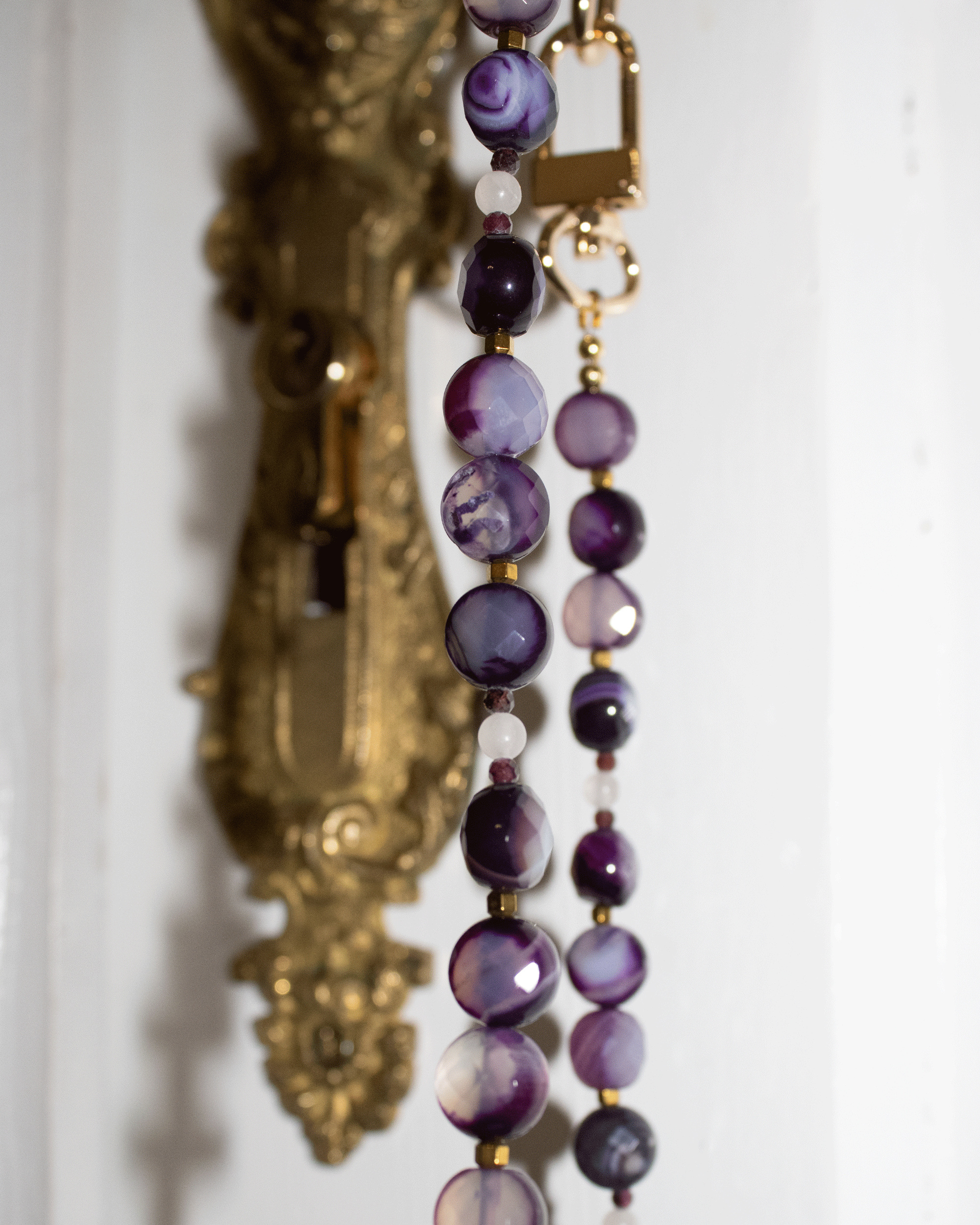 Faceted purple agates and gold-colored hematite