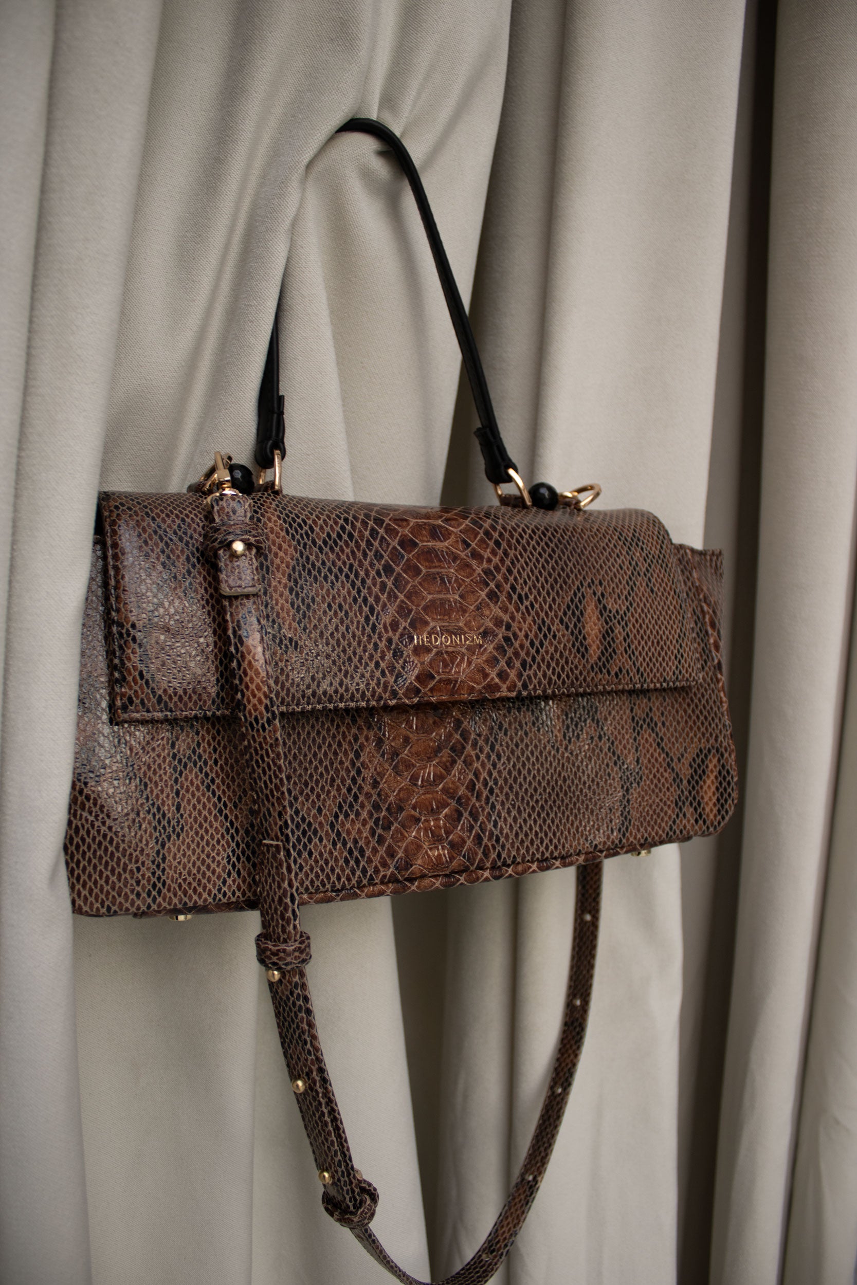 "Ophelia" snake-embossed leather with faceted onyx. Available in two colors.