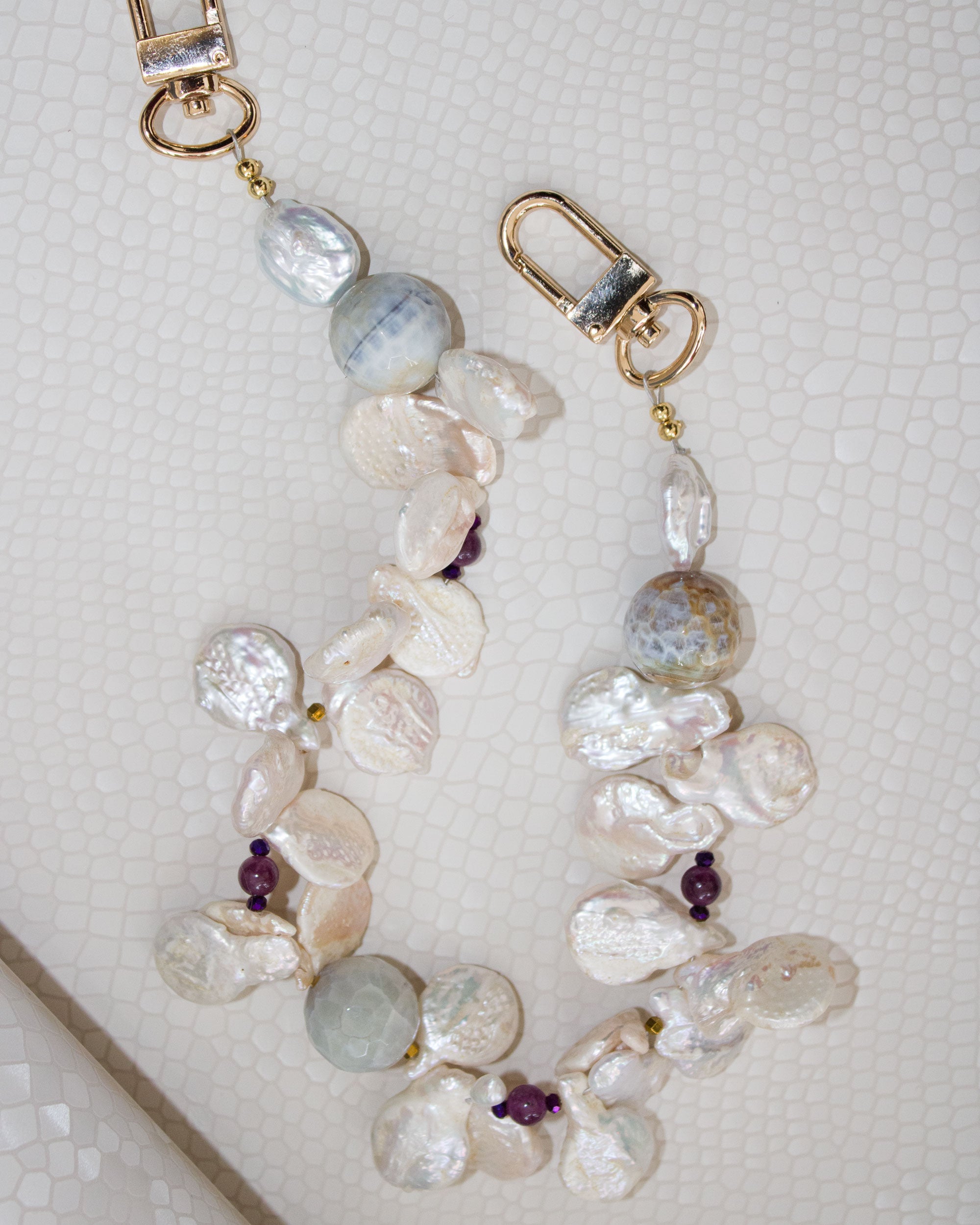 A string of freshwater pearls in two colors, faceted agates, hematite, and jasper. Limited Edition