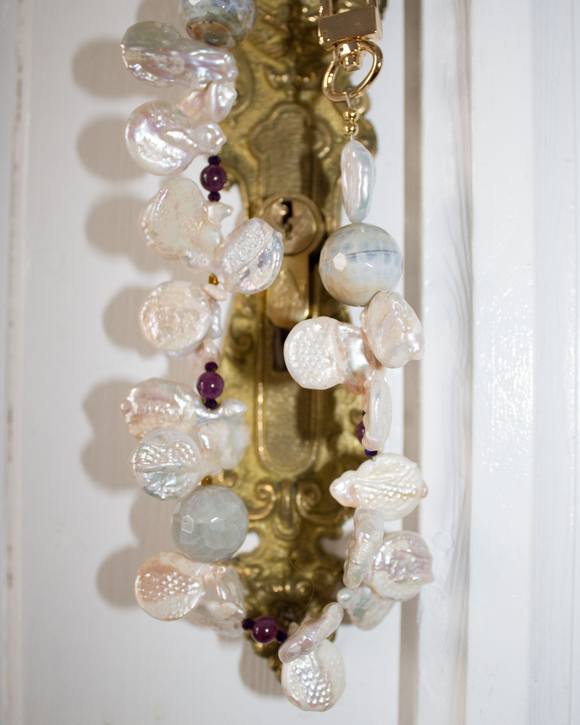 A string of freshwater pearls in two colors, faceted agates, hematite, and jasper. Limited Edition