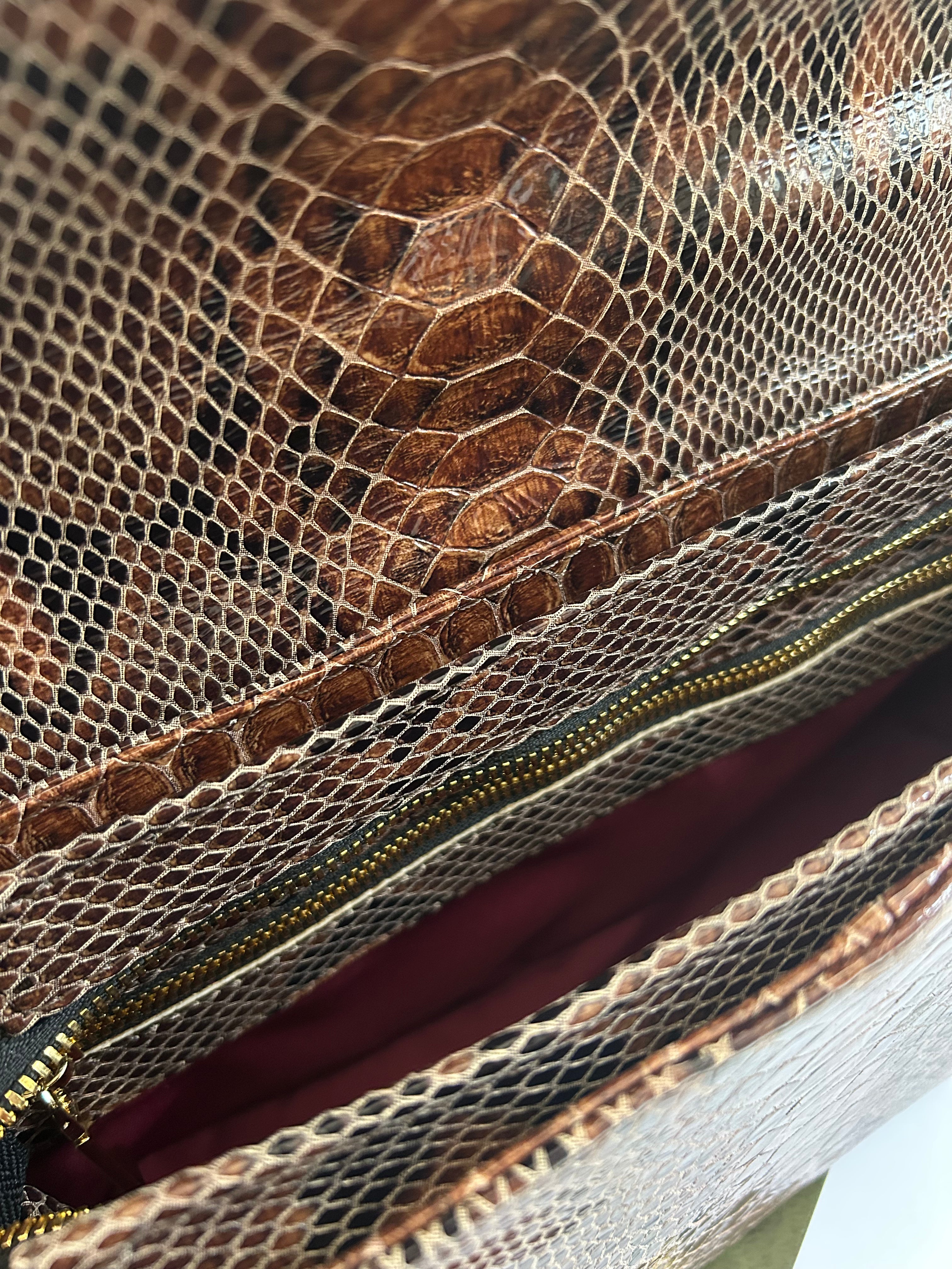 "Audrey M+" snake-embossed leather. Available in two colors.