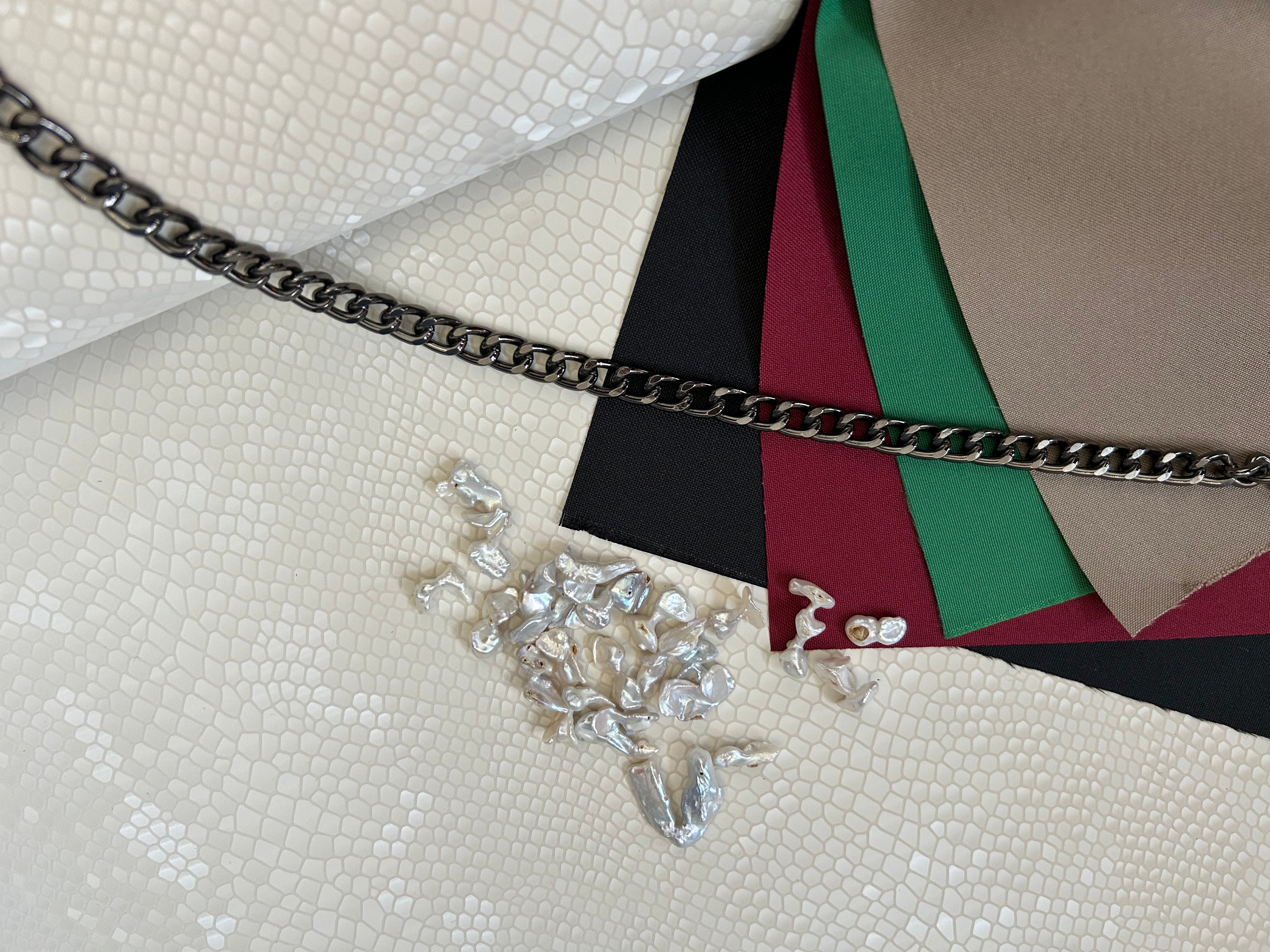 "Audrey M+" snake-embossed leather with freshwater pearls. Available in two colors.