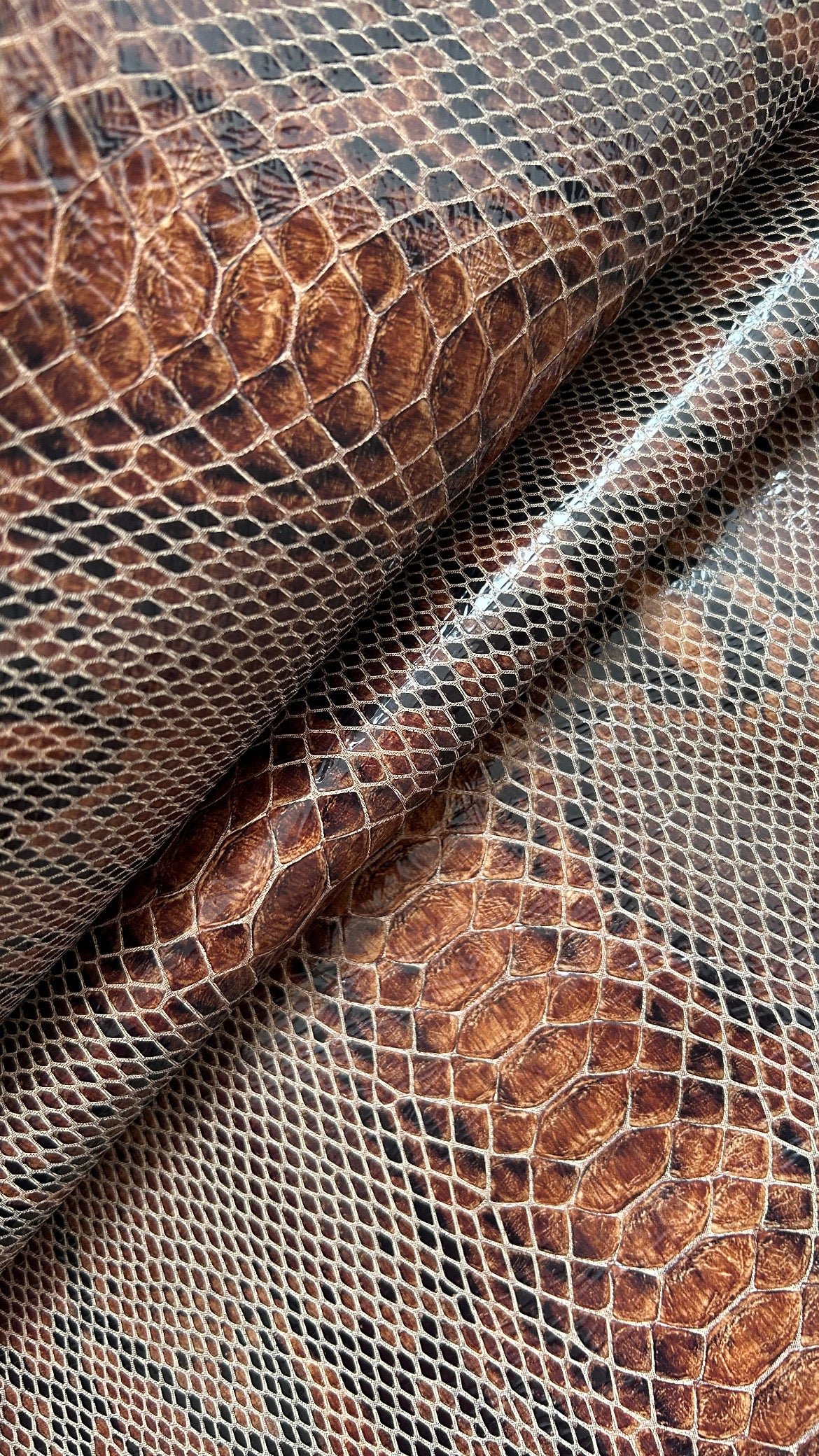 "Audrey M+" snake-embossed leather. Available in two colors.