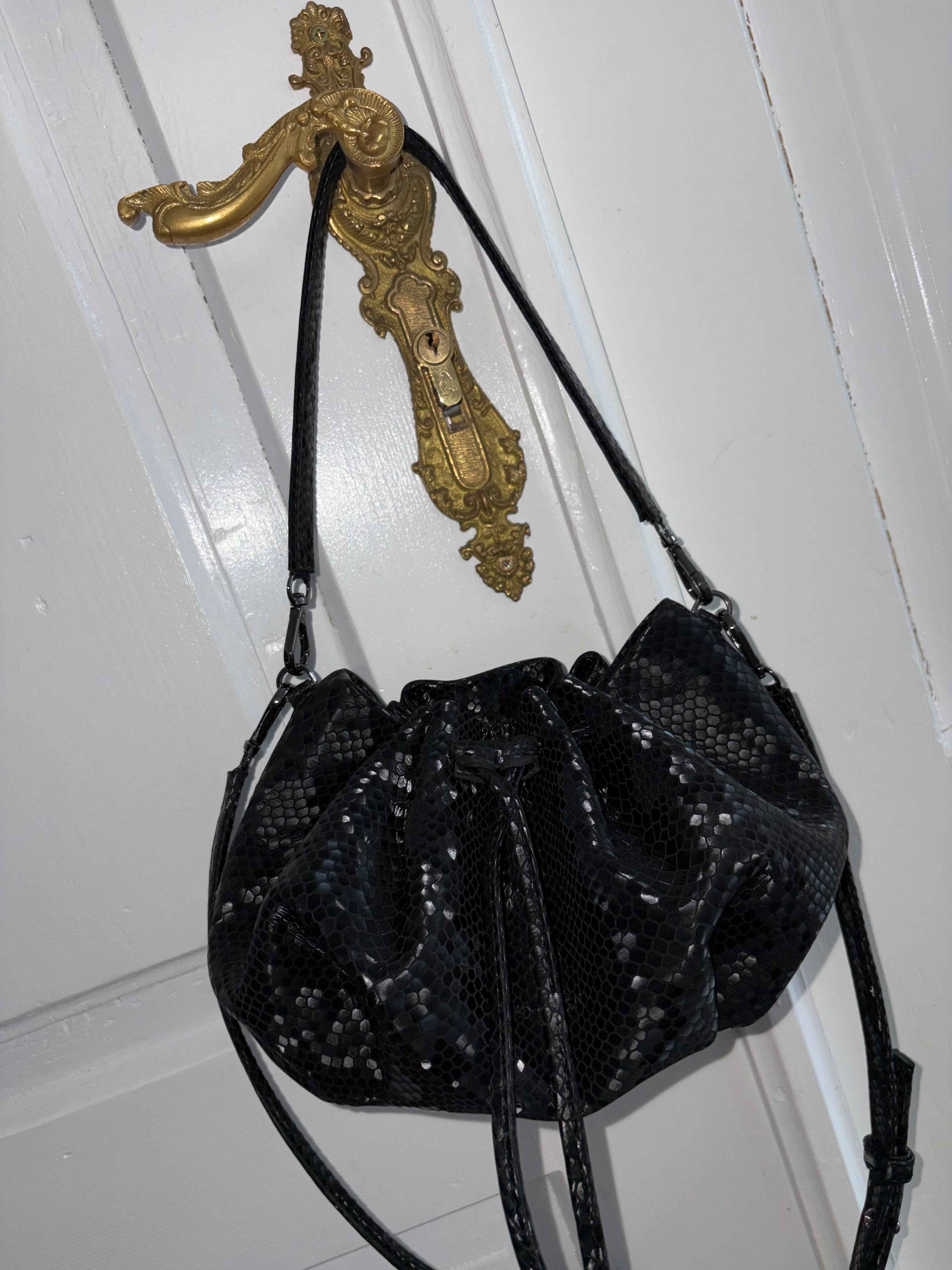 Mini "Retro" bag with a handle and a shoulder strap. Black and white leather.