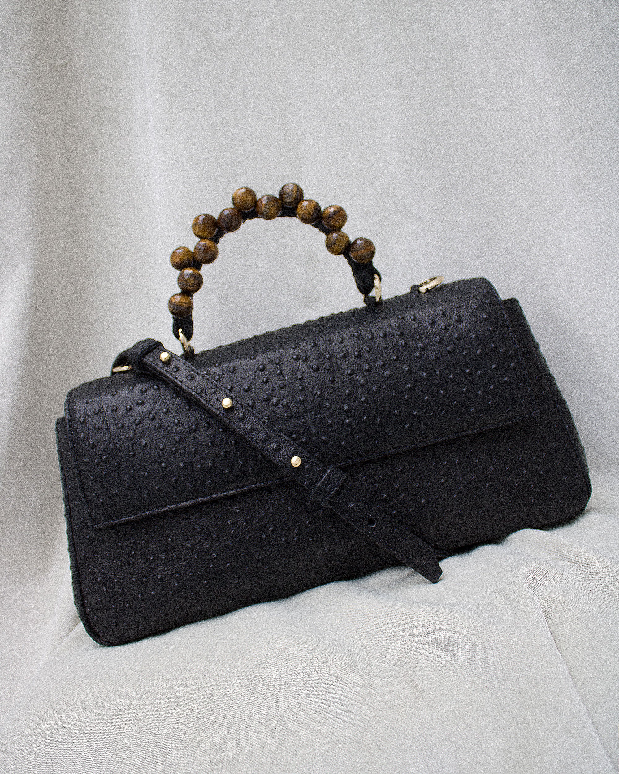 "Audrey Baguette" with tiger's eye, ostrich-embossed leather. Available in two colors