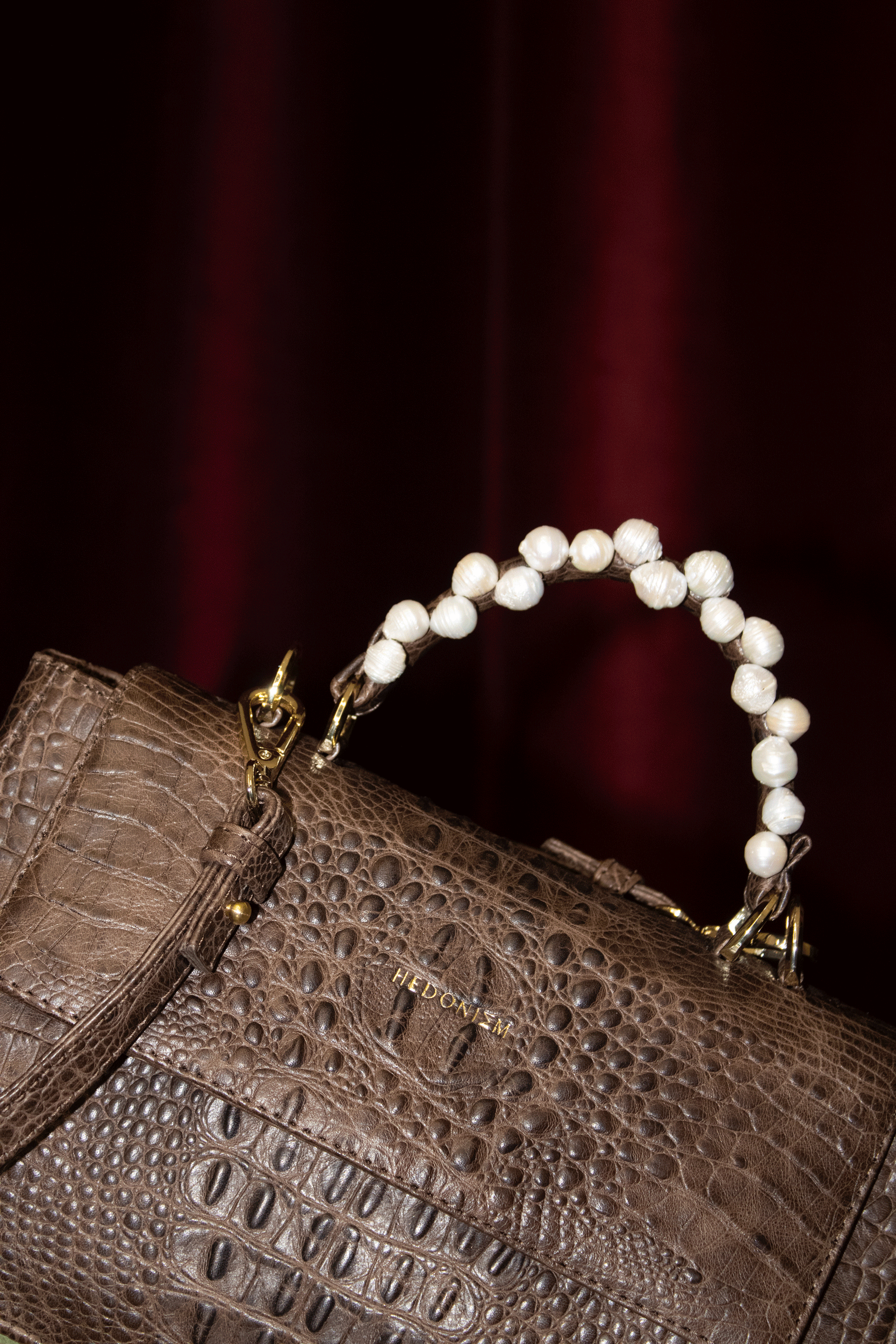 "Audrey" crocodile-embossed leather with freshwater pearls. Available in several colors.