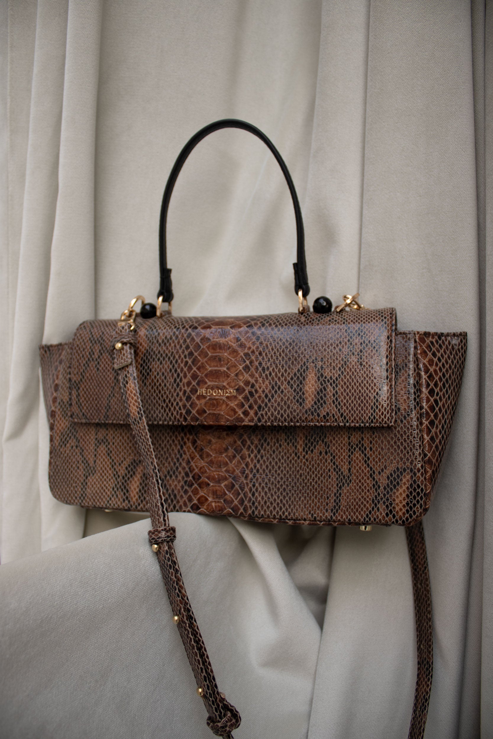 "Ophelia" snake-embossed leather with faceted onyx. Available in two colors.