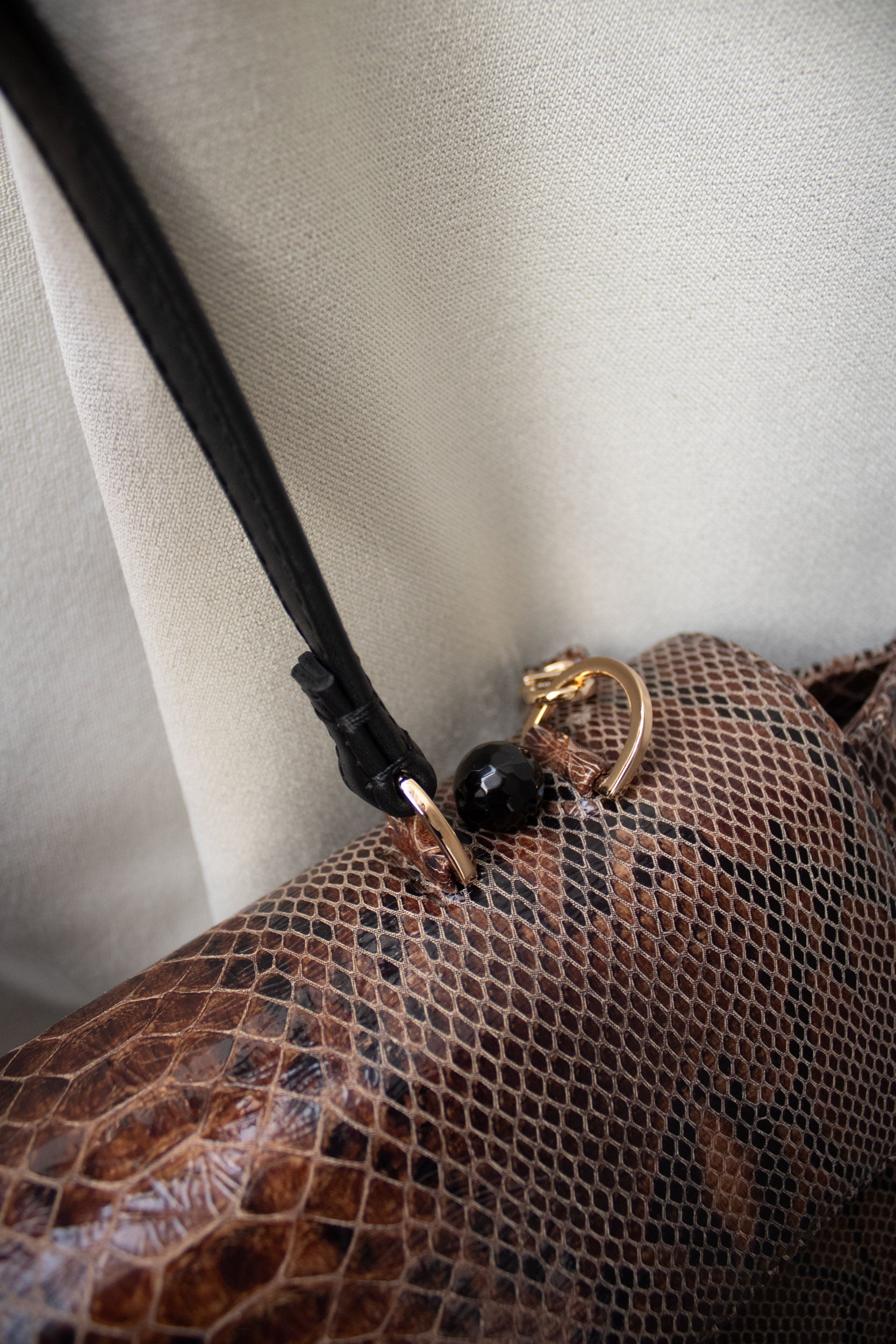 "Ophelia" snake-embossed leather with faceted onyx. Available in two colors.