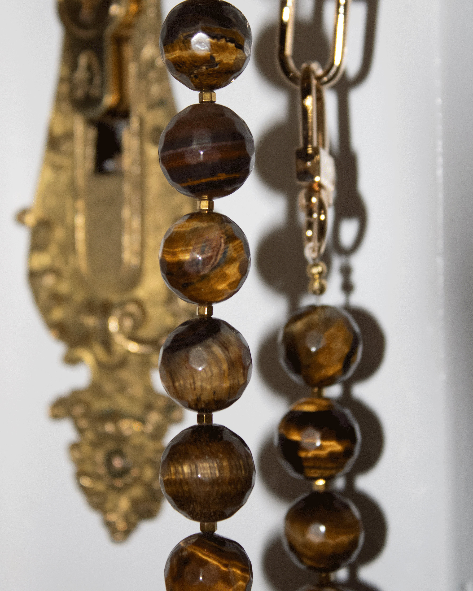 Faceted tiger's eye and gold-colored hematite