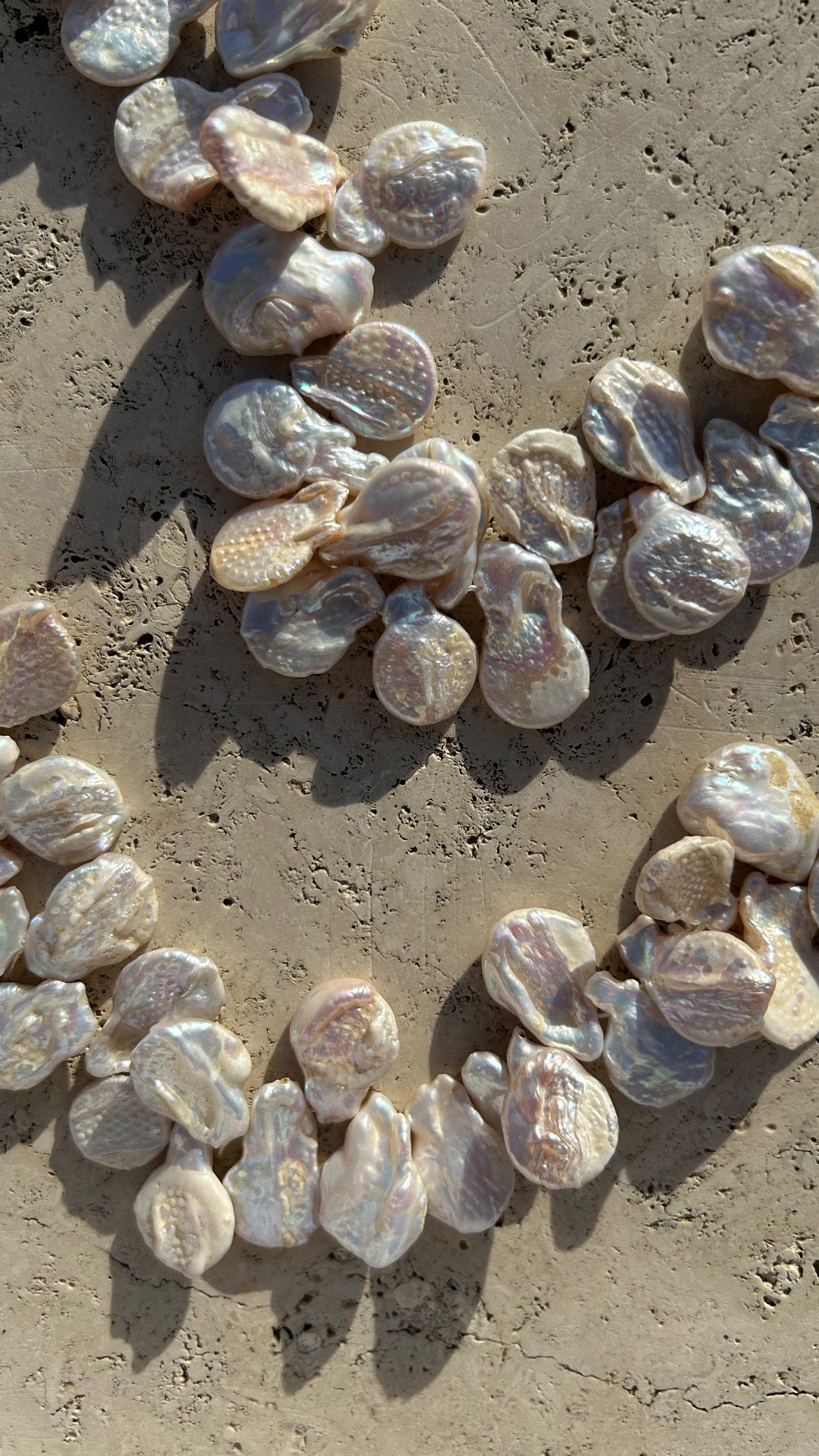 "Audrey" with freshwater pearls and ostrich-effect leather. Two colors